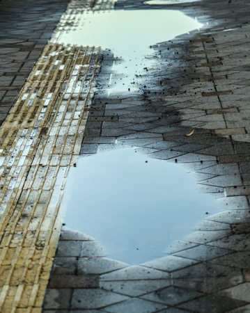 Puddle on the road with reflection .の写真素材