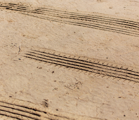 Traces of cars on clay soil as a background .の写真素材
