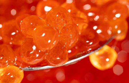 Red caviar on the spoon as a background. Macroの写真素材