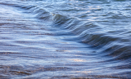Waves on the seashore as an abstract background .