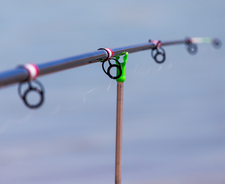 Stand for fishing rods on the beach .