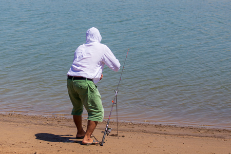 A man catches fish on the lake .の写真素材