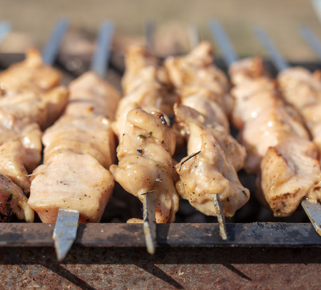 Shish kebab on skewers is fried on a brazier .の写真素材