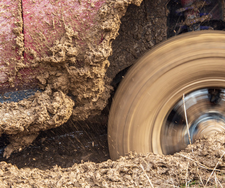 Car wheel slips in the dirt in nature .の写真素材
