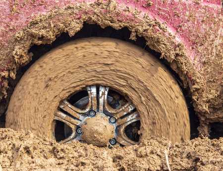 Car wheel slips in the dirt in nature .の写真素材