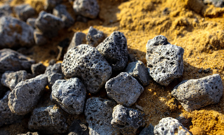 Stones on the edge of the asphalt road .の写真素材