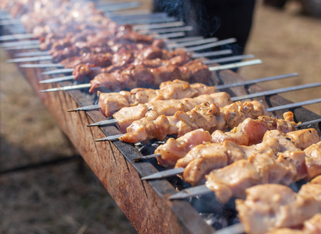 Shish kebab on skewers is fried on a brazier .の写真素材