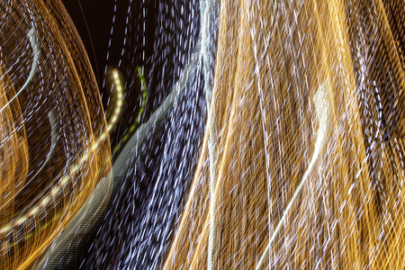 Bulbs glow at night in motion as an abstract background.の写真素材