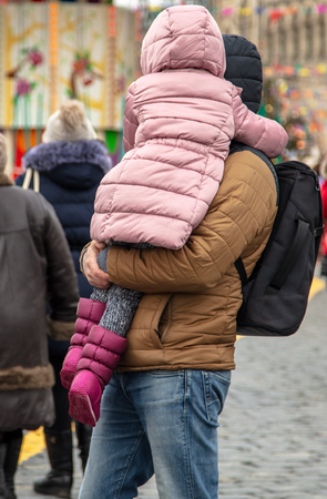 A man holds a daughter in the city in winter .の写真素材