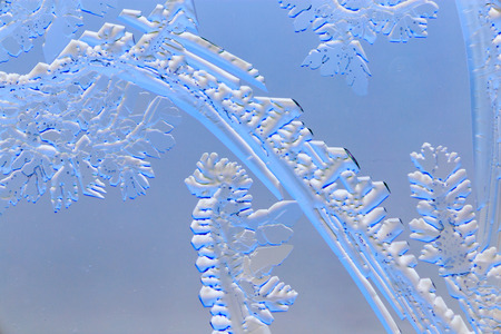 Snow patterns on glass as an abstract background .