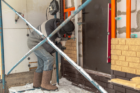 Installing brick siding on the wall of the house .の写真素材