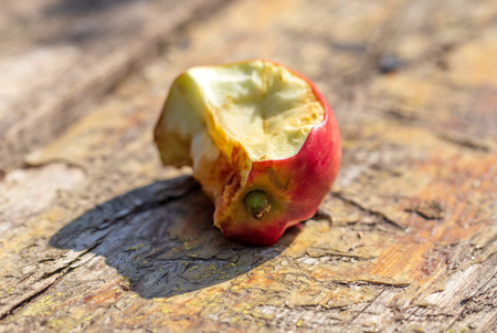 Apple core on wooden background.の写真素材