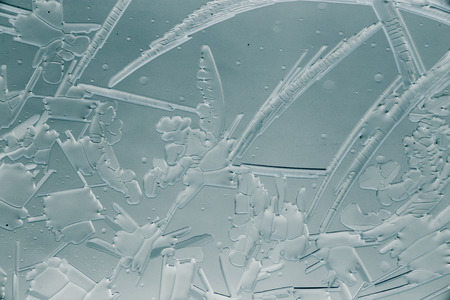 Snow patterns on glass as an abstract background .