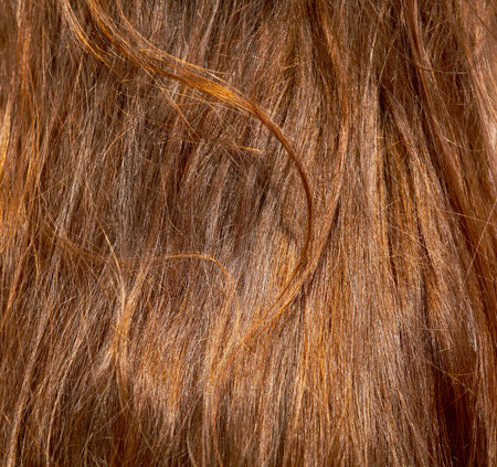 Red hair on the head of the girl as an abstract background.の写真素材