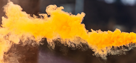 Orange smoke outdoors as background.の写真素材