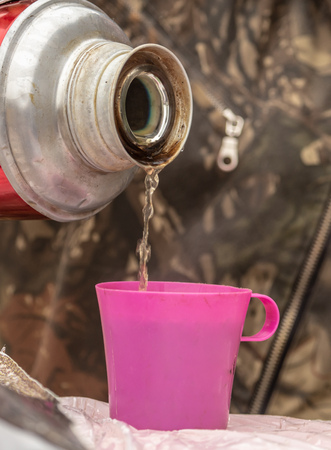 Tea with a thermos in nature.の写真素材
