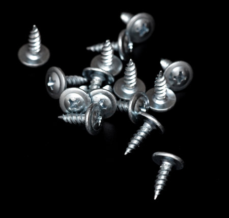 Sharp screws on a black background.の写真素材