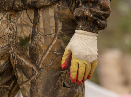 Hands of a worker at a construction site.の写真素材
