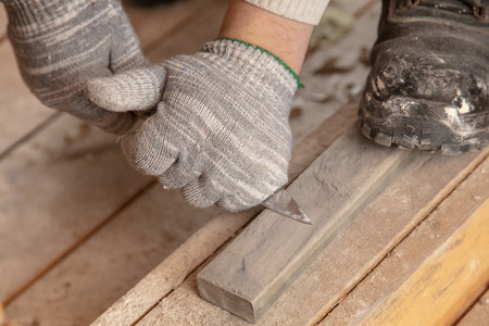 Worker cuts with a knife drywall repair.の写真素材