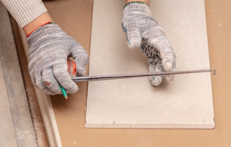 Worker installs drywall on the walls in the room.の写真素材