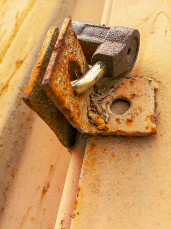 Lock on a rusty metal garage.