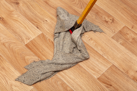 Cleaning a house with a rag on a mop.