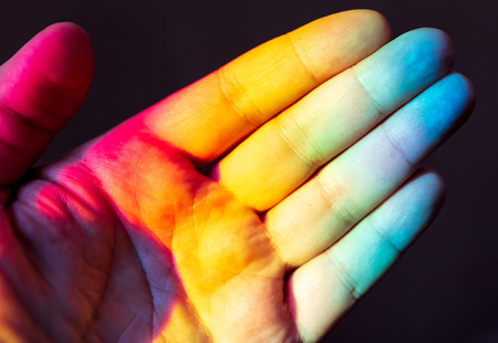 Man's hand in rainbow color .の写真素材