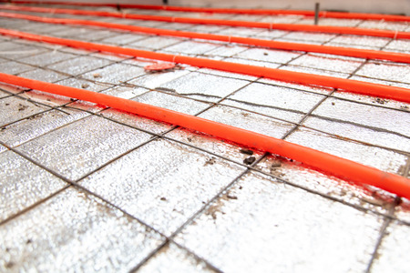 Installing a hose for underfloor heating in the room.の写真素材