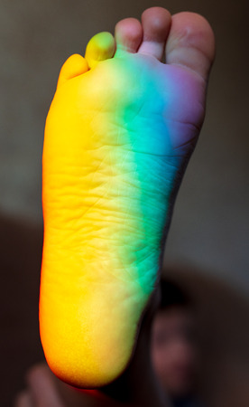 Man's foot in the color of the rainbow .の写真素材