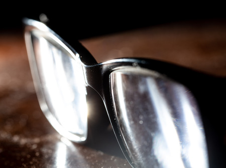 Old glasses lie on the table .の写真素材