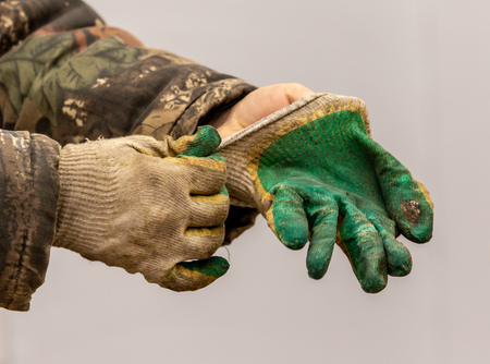 Hands of a worker at a construction site.の写真素材