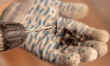 Screws in the hand of a worker.の写真素材