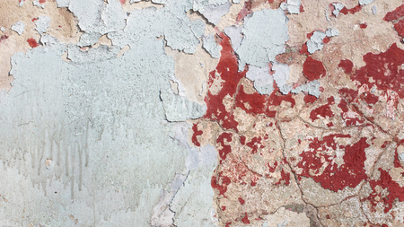 Concrete wall with cracked paint as abstract background.の写真素材