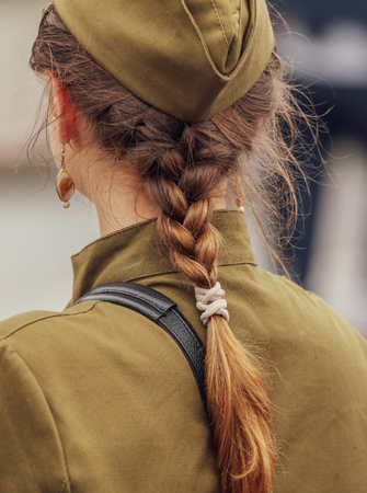 Hair on the head and shoulders of a military girl .の写真素材