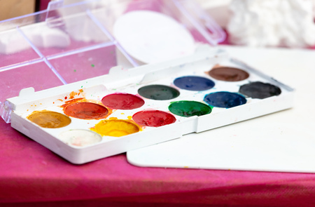 Multi-colored paints are on the table .の写真素材