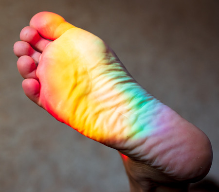 Man's foot in the color of the rainbow .の写真素材