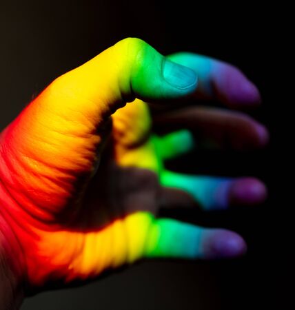Man's hand in rainbow color .の写真素材