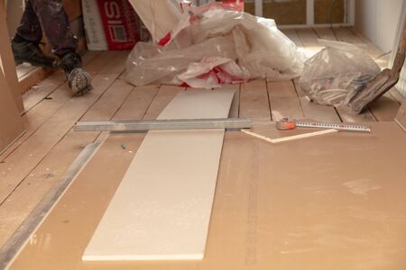 Worker installs drywall on the walls in the room.の写真素材