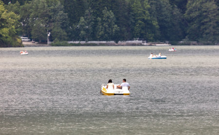 Lake Ritsa, Abkhazia - June 7, 2019: People swim in boats on Lake Ritsa .