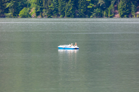 Lake Ritsa, Abkhazia - June 7, 2019: People swim in boats on Lake Ritsa .のeditorial素材