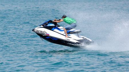 Sochi, Russia - June 4, 2019: People ride on a water bike in the Black Sea .