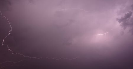 Lightning in the sky at night .
