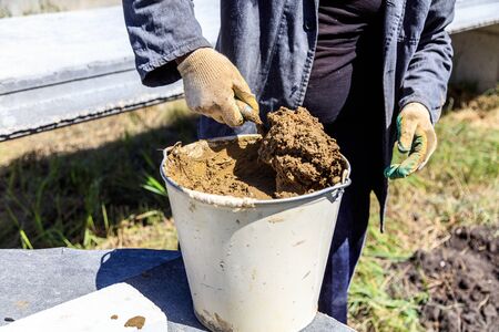 Worker works with concrete at a construction site at home .