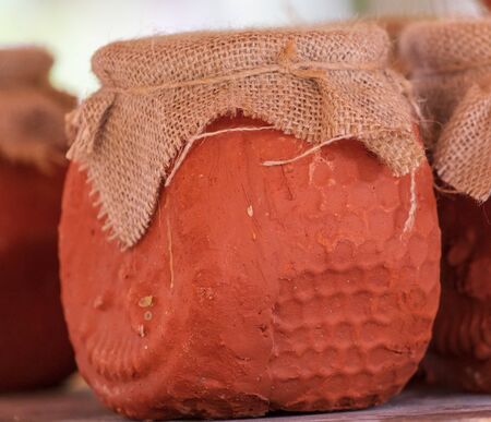Honey in pottery in the market .