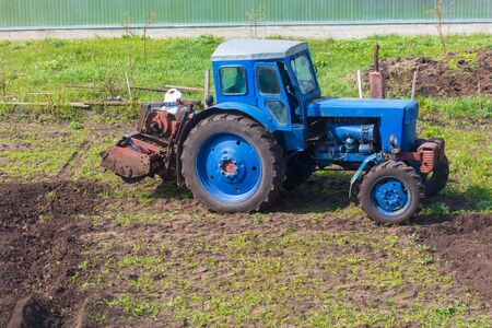 Tractor plowing soil in spring .の写真素材