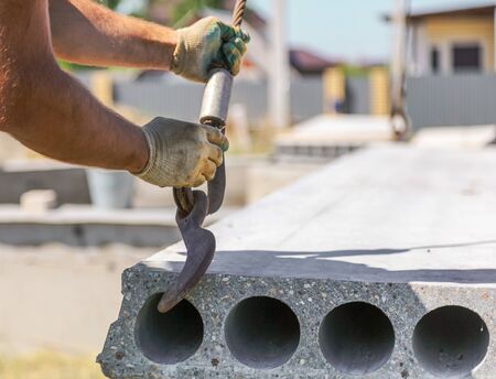 Installing concrete slabs at a construction site at home .