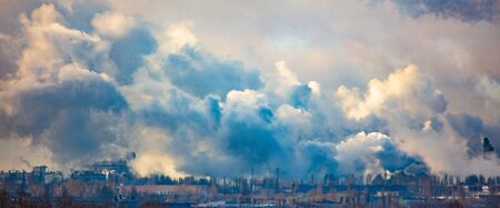The smoke from the pipes of the metallurgical plant pollutes the environmentの写真素材