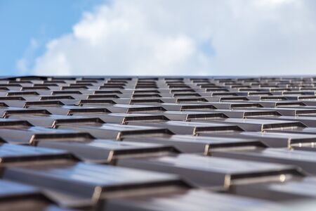 The roof of metal on a background of blue sky .