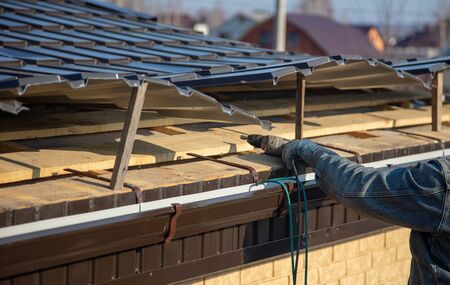 Installation of metal drain on the roof of the house .の写真素材