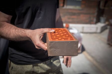 Brick laying in the wall at a construction site at home .の写真素材